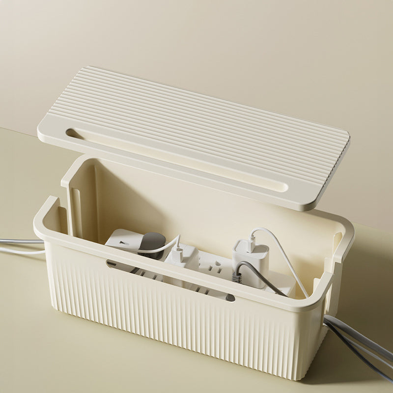 Open cable organizer box holding a compatible power strip and chargers